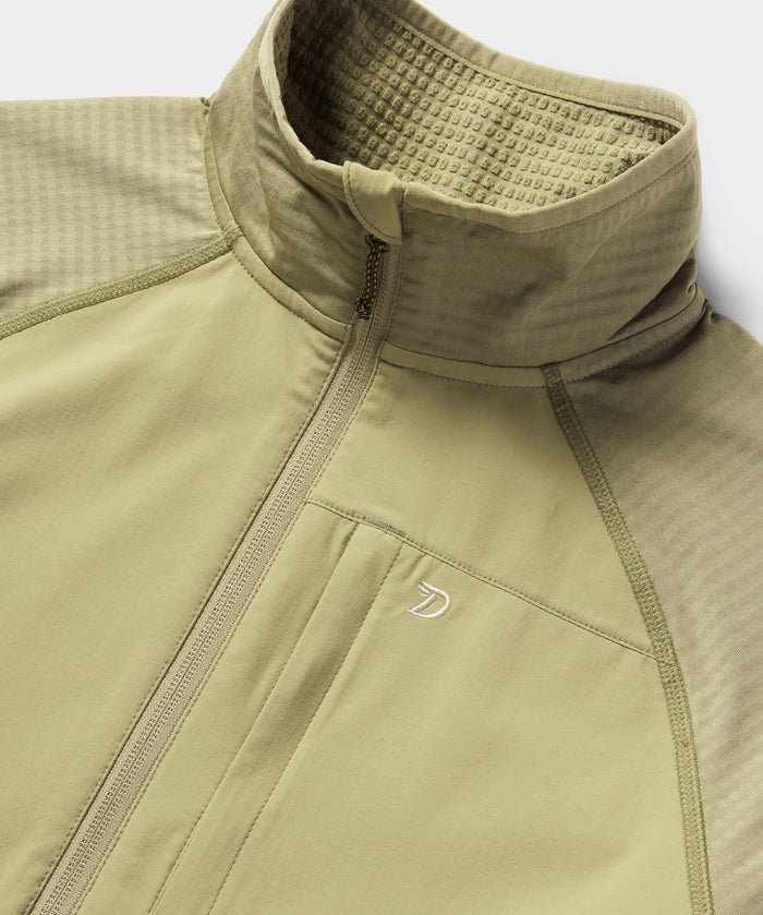 Close-up of Duck Camp’s W's Lightweight Grid Tech Fleece Half Zip in Sagebrush, featuring a high collar, chest pocket, textured panels, and subtle logo—making it the perfect lightweight midlayer.