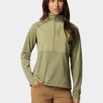 A woman wears the Duck Camp W's Lightweight Grid Tech Fleece Half Zip in Sagebrush with tan cargo pants, standing facing forward with one hand in her pocket against a plain background.