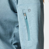 Close-up of the Duck Camp W's Rockport Hoodie in Heathered Trooper, showing a light blue sleeve with a small vertical zippered pocket and visible stitching, made from cooling material for comfort.