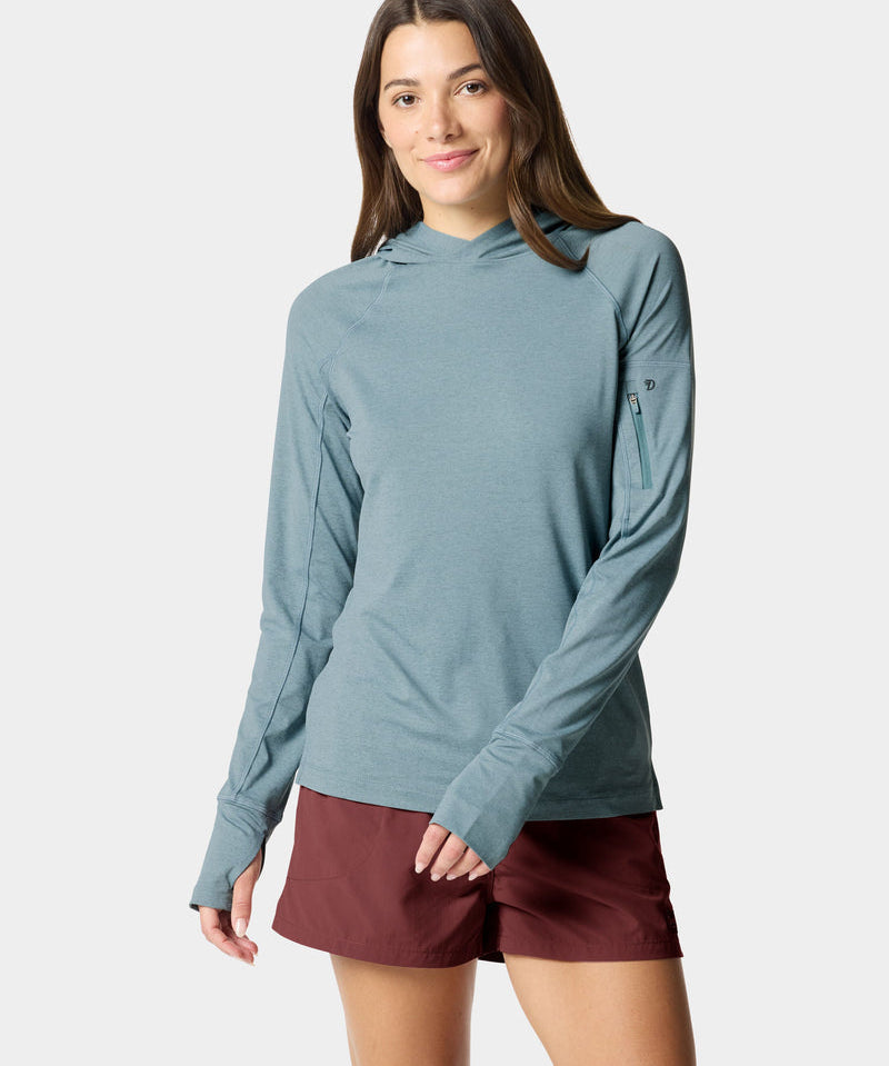 A woman wearing the Duck Camp W's Rockport Hoodie Heathered Trooper stands against a plain light background, facing forward and smiling slightly.