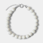 The Yona Collar by Kara Yoo features round white beads with a silver chain extender and clasp, arranged in a circle on a plain light background—an ideal choice for lovers of handmade Vancouver jewelry.