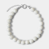 The Yona Collar by Kara Yoo features round white beads and a silver clasp with an adjustable chain, designed in Vancouver and shown on a plain light background.