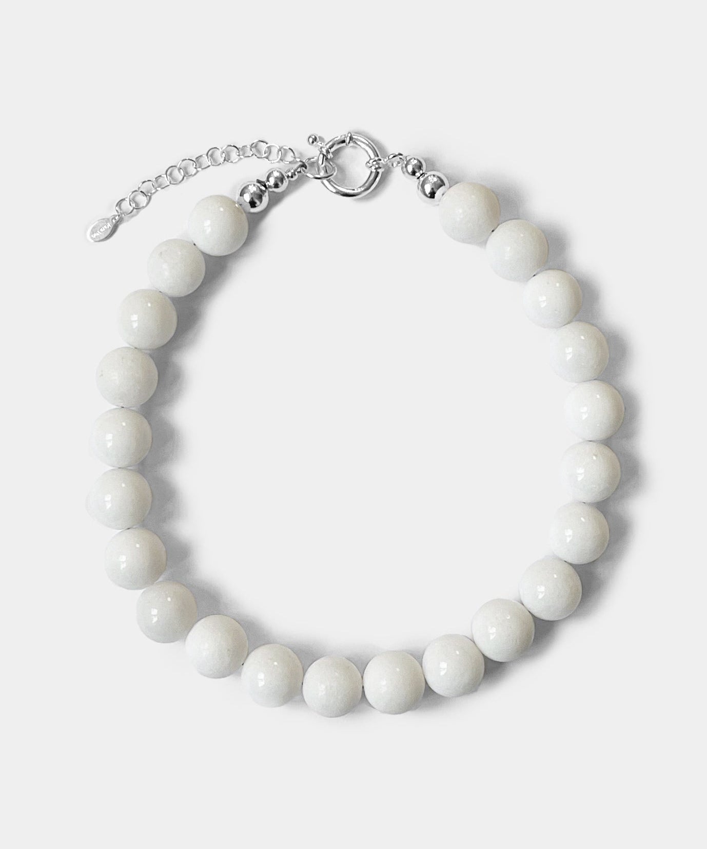 The Yona Collar by Kara Yoo features round white beads and a silver clasp with an adjustable chain, designed in Vancouver and shown on a plain light background.