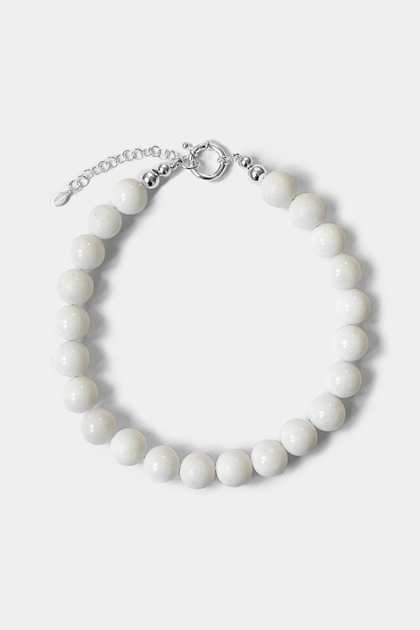 The Yona Collar by Kara Yoo features round white beads and a silver clasp with an adjustable chain, designed in Vancouver and shown on a plain light background.