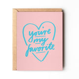The "You're My Favorite" greeting card by Daydream Prints features a pink design with a blue heart outline and handwritten message, plus a recycled envelope—thoughtfully crafted in Portland.