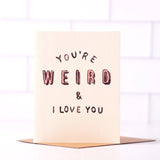 Daydream Prints’ “You’re Weird & I Love You” A2 card features pink and black text on a white tiled background, comes with a recycled envelope, and is made in Portland—perfect for celebrating quirky connections.