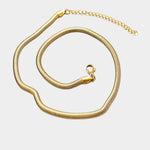The Zoe Gold Snake Chain Necklace by Peter and June is a waterproof, gold-plated necklace with a lobster clasp and adjustable extender, shown on a white background.