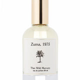 A clear glass perfume bottle with a gold cap, labeled "Zuma | Thin Wild Mercury" by Thin Wild Mercury (50 ml), features a black palm tree and contains a Malibu-inspired ocean scent.