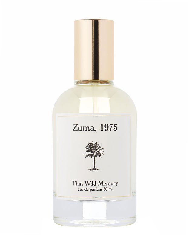A clear glass perfume bottle with a gold cap, labeled "Zuma | Thin Wild Mercury" by Thin Wild Mercury (50 ml), features a black palm tree and contains a Malibu-inspired ocean scent.