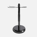 The Rockwell Razors 3-Piece Shave Stand features a metal design with a round base, central pole, and two hooks—ideal for organizing double-edge razors and brushes for wet shavers.