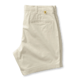 A pair of 7 in Gold School chino shorts by Duck Head in beige, neatly folded, featuring a 7-inch inseam, belt loops, and a single buttoned back pocket.