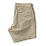 The Duck Head 7 in Gold School chino shorts feature a 7-inch inseam, back pocket, belt loops, and a small yellow logo above the pocket, shown against a plain white background.