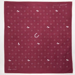The Jenni Earle "Blaze A Trail" Bandana is hand-dyed maroon with white horse, horseshoe, and cross motifs, plus "keep a trail" text—ideal for trailblazers and adventurers.