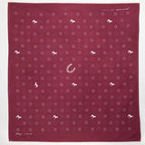 The Jenni Earle "Blaze A Trail" Bandana is hand-dyed maroon with white horse, horseshoe, and cross motifs, plus "keep a trail" text—ideal for trailblazers and adventurers.