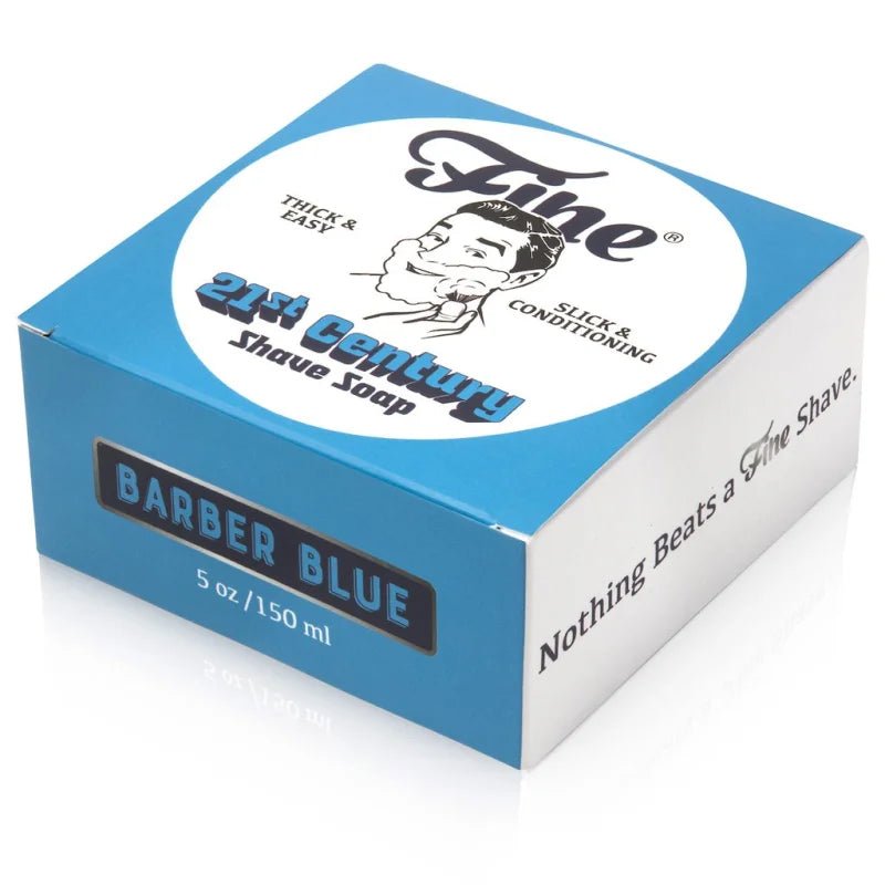 A blue and white box of Fine Accoutrements' Barber Blue 21C Shave Soap, 5 oz, showcases retro branding and highlights a barbershop scent with tallow base for superior shaving.