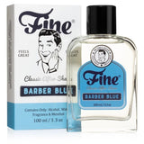 A 100ml bottle of Barber Blue Classic Aftershave by Fine Accoutrements sits before its box, featuring vintage art of a smiling man—an homage to the classic charm of traditional aftershaves like Floid Blue.
