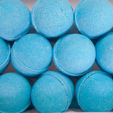 Twelve Coastal Calm bath bombs by Old Whaling Co., enriched with Epsom salts and an ocean-inspired scent, are arranged in three rows inside the box.