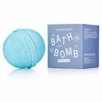A blue Bath Bomb | Coastal Calm by Old Whaling Co. rests beside its light blue box, infusing your bath with ocean scent, epsom salts, and coastal tranquility.