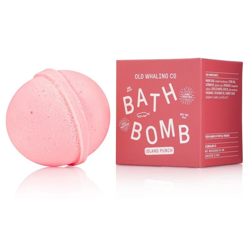 A pink handmade "Bath Bomb | Island Punch | Old Whaling Co." rests beside its matching box from Old Whaling Co., promising a tropical bath bomb experience.
