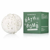 A white bath bomb with dark specks sits beside a green box labeled “Bath Bomb | Spearmint + Eucalyptus | Old Whaling Co.” The box features the brand Old Whaling Co. and lists essential oils and epsom salts among the ingredients.