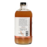 A clear glass bottle of Yes Cocktail Co. Blood Orange & Chili Pepper Cocktail Mixer, featuring a back label with text and website and capped with a black top—perfect for crafting a spicy margarita.