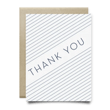The Blue Stripes Thank You Card by Anvil Cards features diagonal navy lines and a bold "THANK YOU" on white linen paper, paired with a brown envelope. The A2 card is blank inside for your message.