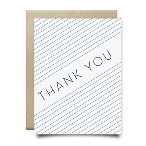 The Blue Stripes Thank You Card by Anvil Cards features diagonal navy lines and a bold "THANK YOU" on white linen paper, paired with a brown envelope. The A2 card is blank inside for your message.