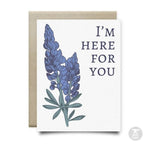 The Bluebonnets Here For You Card by Anvil Cards features bluebonnet art and "I'M HERE FOR YOU" on linen paper. This A2 card is blank inside and comes with an envelope placed behind it.