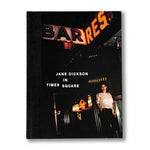 The book "Jane Dickson in Times Square" by Anthology Editions features a cover of Jane Dickson on a New York street at night, with neon signs reading "BAR" and "REST," reflecting the Colab art collective’s spirit.