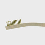 A close-up of the Otter Wax Brass Cleaning Brush, a versatile brush with light-colored bristles, shown against a plain white background.