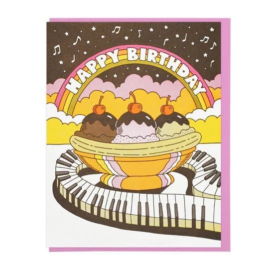 The Cards | Happy Birthday Musical Banana Split by Lucky Horse Press features a banana split with three scoops, cherries, a rainbow, and piano keyboard trail. Letterpress printed on recycled cover, blank inside, “Happy Birthday” in bold letters above.