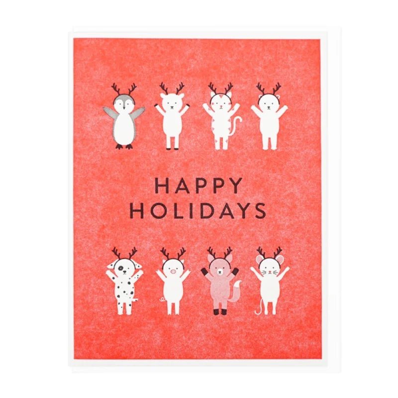 The Lucky Horse Press "Happy Holidays Antler Friends" card features eight red letterpress-printed cartoon animals with antlers, including a penguin, bear, cat, dog, and pig. Printed in the USA on recycled cover.