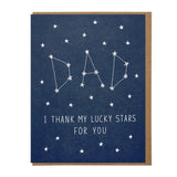 The Lucky Stars Dad greeting card by Lucky Horse Press features white stars forming "DAD" as constellations with "I THANK MY LUCKY STARS FOR YOU" on a dark blue background. Letterpress printed on recycled cover and made in the USA.