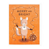 The Cards | Merry & Bright Fox by Lucky Horse Press features a fox in a tuxedo holding festive lights with "Merry and Bright" on an orange background. This letterpress card brings charm to any holiday occasion.
