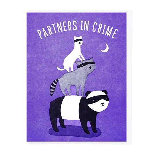 Playful letterpress card by Lucky Horse Press featuring a cat, raccoon, and panda in masks under "PARTNERS IN CRIME" with a crescent moon on purple. Made in USA. Product: Cards | Partners In Crime | Lucky Horse Press.
