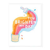 A paintbrush paints colorful stripes from a smiling paint can, forming "You Brighten My Day." This cheerful letterpress card by Lucky Horse Press is made in the USA.