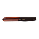 A pocket-sized brown and black folding comb from Uppercut Deluxe, the CT7 Flip Comb, features "Uppercut Deluxe CT7" printed on its handle.