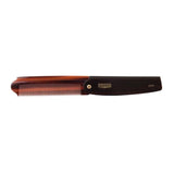 A pocket-sized brown and black folding comb from Uppercut Deluxe, the CT7 Flip Comb, features "Uppercut Deluxe CT7" printed on its handle.