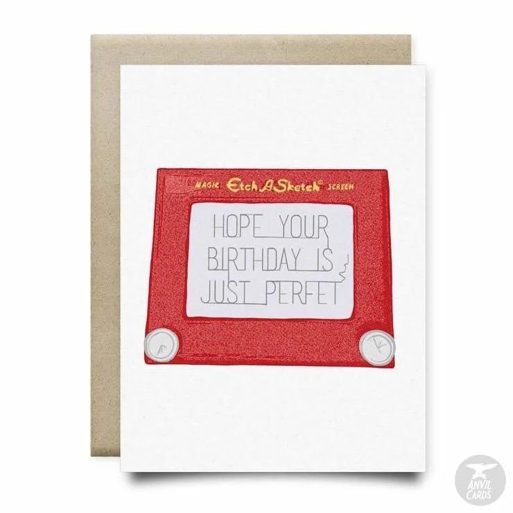 The Etch a Sketch Birthday Card by Anvil Cards is an A2 linen card with a red Etch A Sketch and the message "HOPE YOUR BIRTHDAY IS JUST PERFET" (missing "C"). Blank inside for your own note.