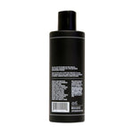 A black Everyday Conditioner | Uppercut Deluxe bottle for men, shown from the back, displays product details and ingredients like olive leaf extract in white text.