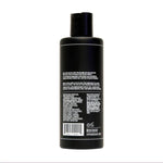 A black plastic bottle of Uppercut Deluxe Everyday Shampoo shown from the back, with white product info text and a barcode—perfect addition to men's hair care routines and styling essentials.