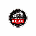 An 18g tin of Uppercut Deluxe Featherweight Paste with a black, white, and red label featuring two boxers. The text highlights its firm hold, pliable texture, and natural low shine finish. Brand: Uppercut Deluxe.