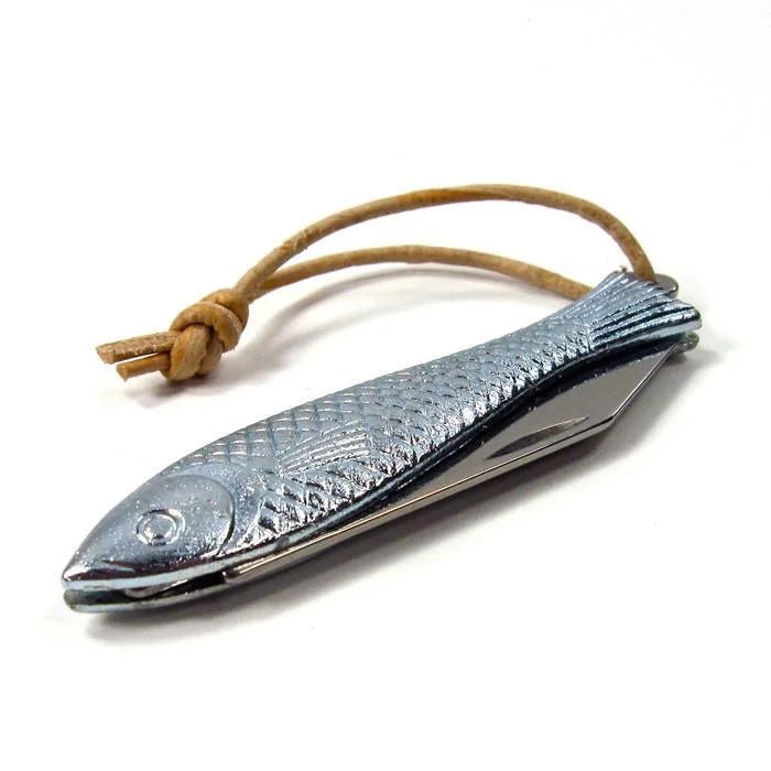 The Mollyjogger Fingerling Fish Knife is a metal, fish-shaped tool with a textured surface, stainless blade, and brown leather loop.