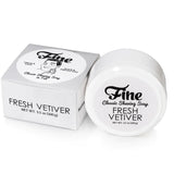 A tub and box of Fine Accoutrements Fresh Vetiver Classic Shaving Soap in tub, tallow-based for a classic barbershop shave, each labeled with product name and net weight (3.5 oz/100 g), displayed on a white background.