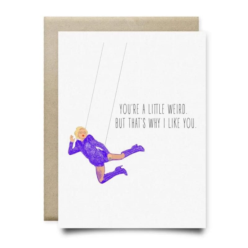 The Gaga You’re a Little Weird Card by Anvil Cards is an A2 linen paper greeting card showing a person swinging in purple with "YOU'RE A LITTLE WEIRD. BUT THAT'S WHY I LIKE YOU." on the front. Blank inside for your message.