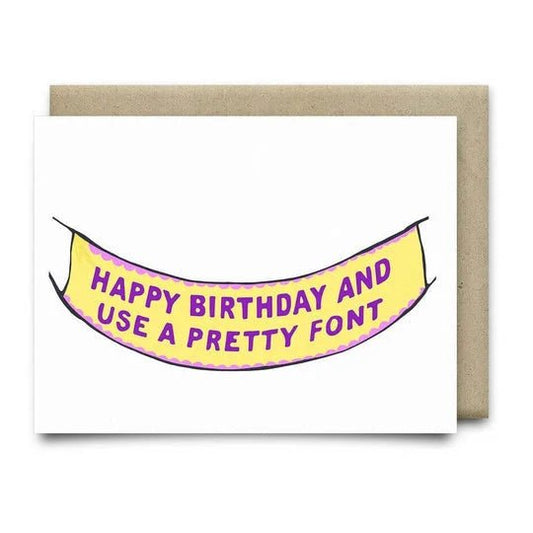 The Happy Birthday Banner Card by Anvil Cards features a yellow banner with purple "HAPPY BIRTHDAY AND USE A PRETTY FONT" text, is printed on linen A2 card stock, blank inside, and comes with a brown envelope.