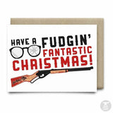 The "Have a Fudgin' Fantastic Christmas Card" by Anvil Cards features glasses, a BB gun illustration, and bold black and red text on linen paper. A2 size; blank inside for your message.