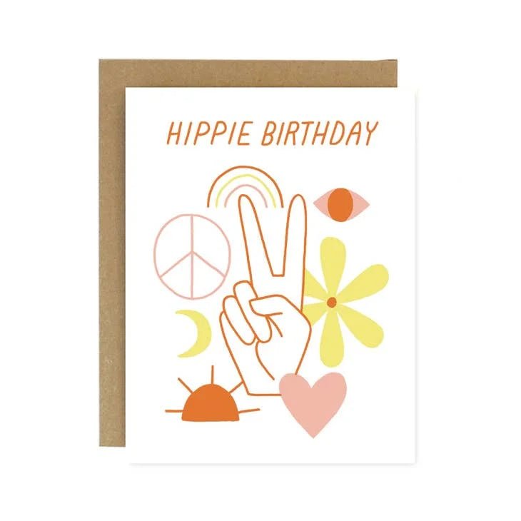 The Hippie Birthday Card by Worthwhile Paper features "Hippie Birthday" text, peace sign hand, sun, rainbow, moon, flower, heart & more. Screen printed on recycled white paper with a brown envelope. Folded A2 size.