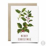 The Holly Merry Christmas Card by Anvil Cards features holly artwork and "Merry Christmas" in red, printed on linen paper with a brown envelope. This A2 card is blank inside for your own message.