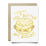 The Honey You Butter My Biscuit Card by Anvil Cards is an A2 linen greeting card with a biscuit illustration and "Honey, you butter my biscuit" in yellow text. Blank inside for your message.